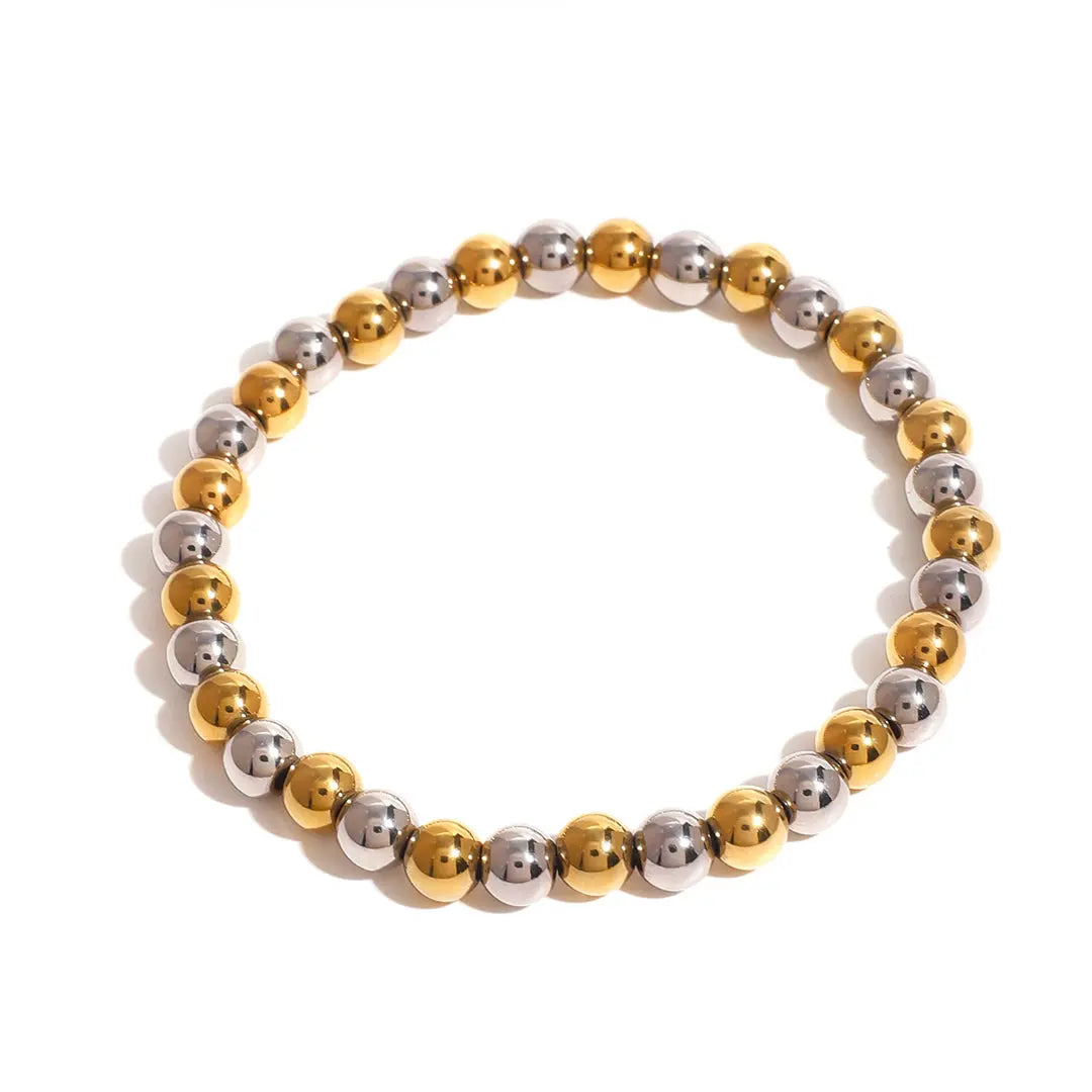 Bracelet with gold and silver beads on a white background