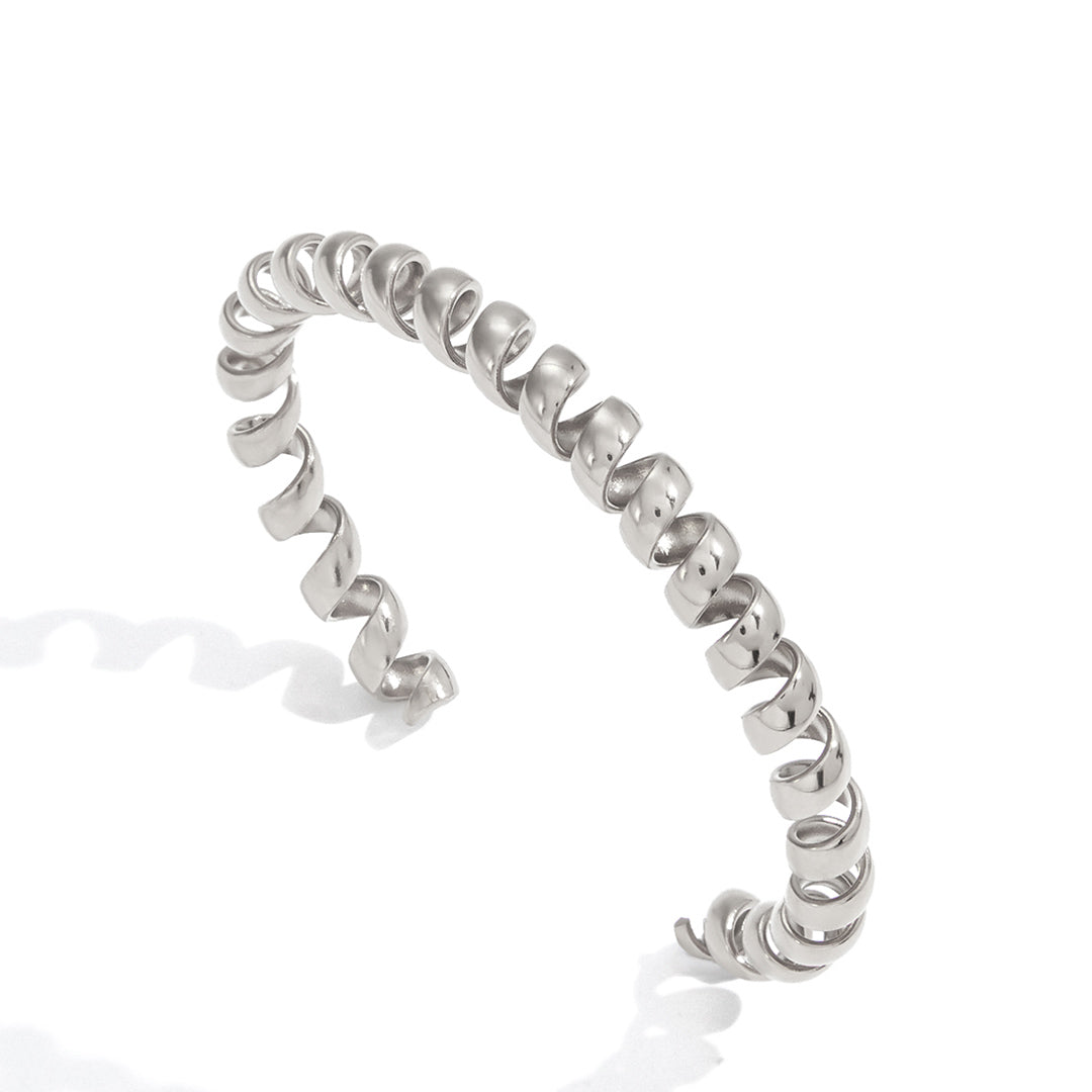 Silver spiral cuff bracelet with sculptural open wrapped design in polished stainless steel