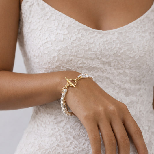 Double-strand pearl and crystal bracelet styled with black outfit, gold toggle clasp