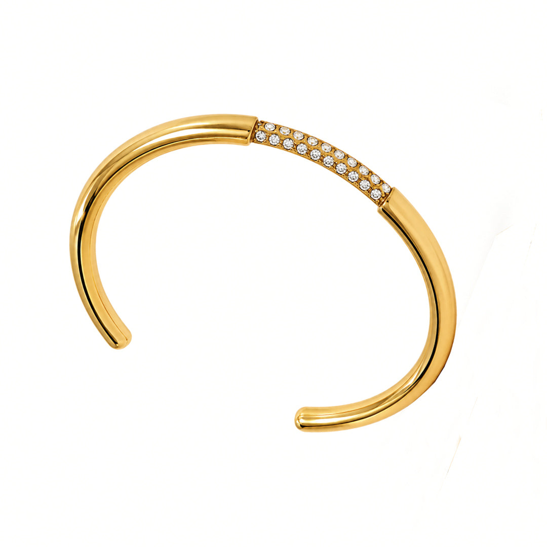 Gold bracelet with small diamonds on a white background