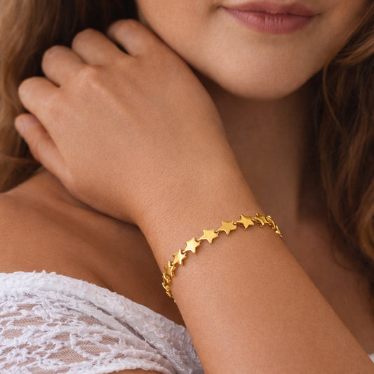 Gold-plated star link bracelet on wrist, Astra sculpted star design