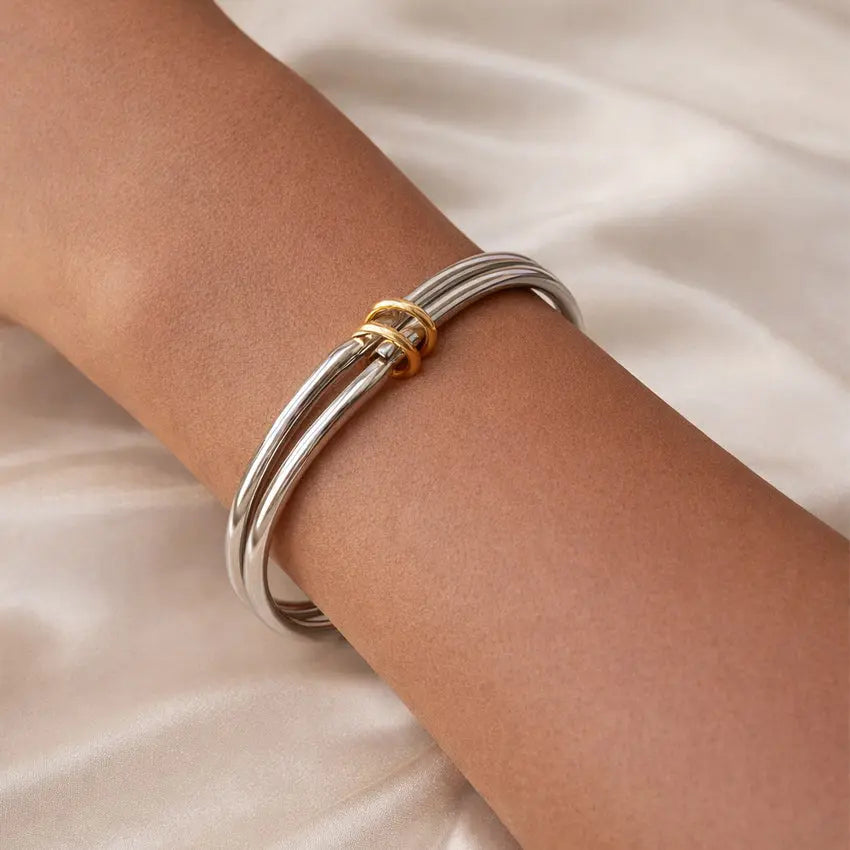 Trinity Double Tone bangle on wrist, silver tone with gold-tone rings