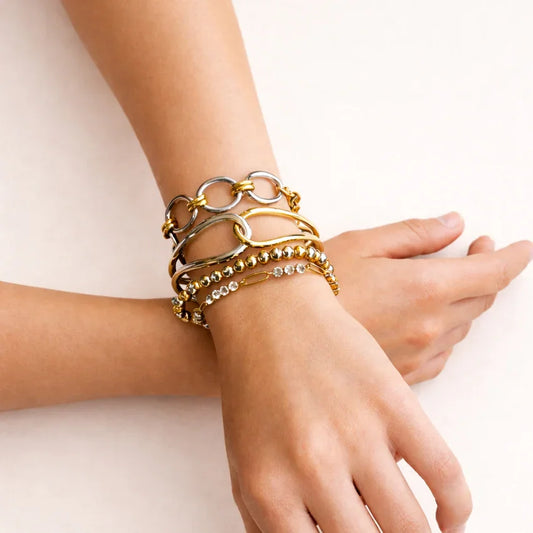 Double tone statement stack on wrist, mixed-metal layered bracelets with carabiner links and beads