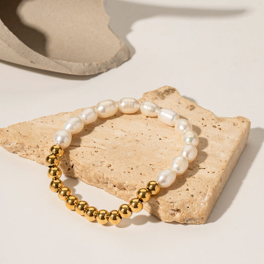 Pearl and gold sphere bracelet styled in a stack, freshwater pearls and polished gold beads