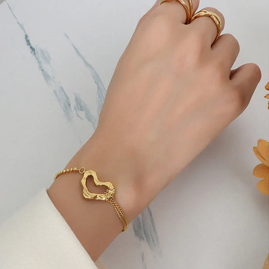 OROR sculpted heart chain bracelet on wrist, PVD gold-plated stainless steel