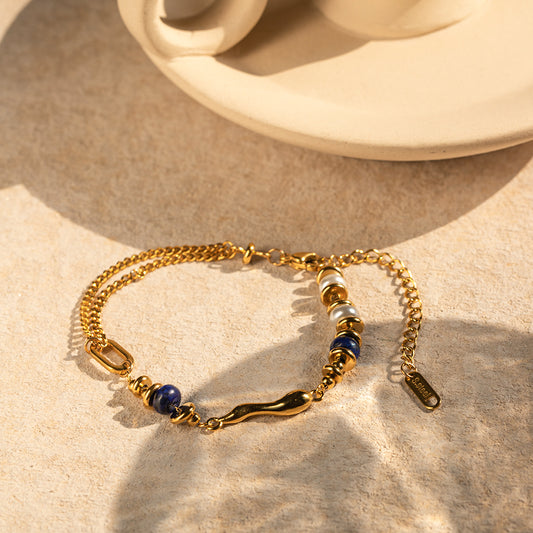 Lapis blue accent bracelet close-up, gold finish with deep blue details