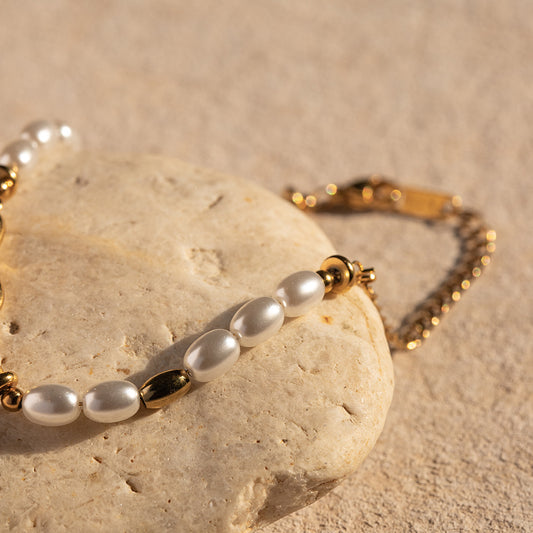 Gold bracelet with lapis blue accents, product view on stone surface