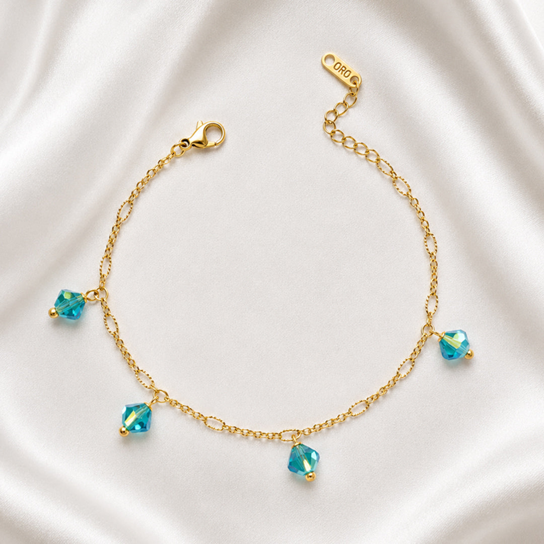 Azure Anklet in 18K PVD gold plating with four blue faceted crystal charms.