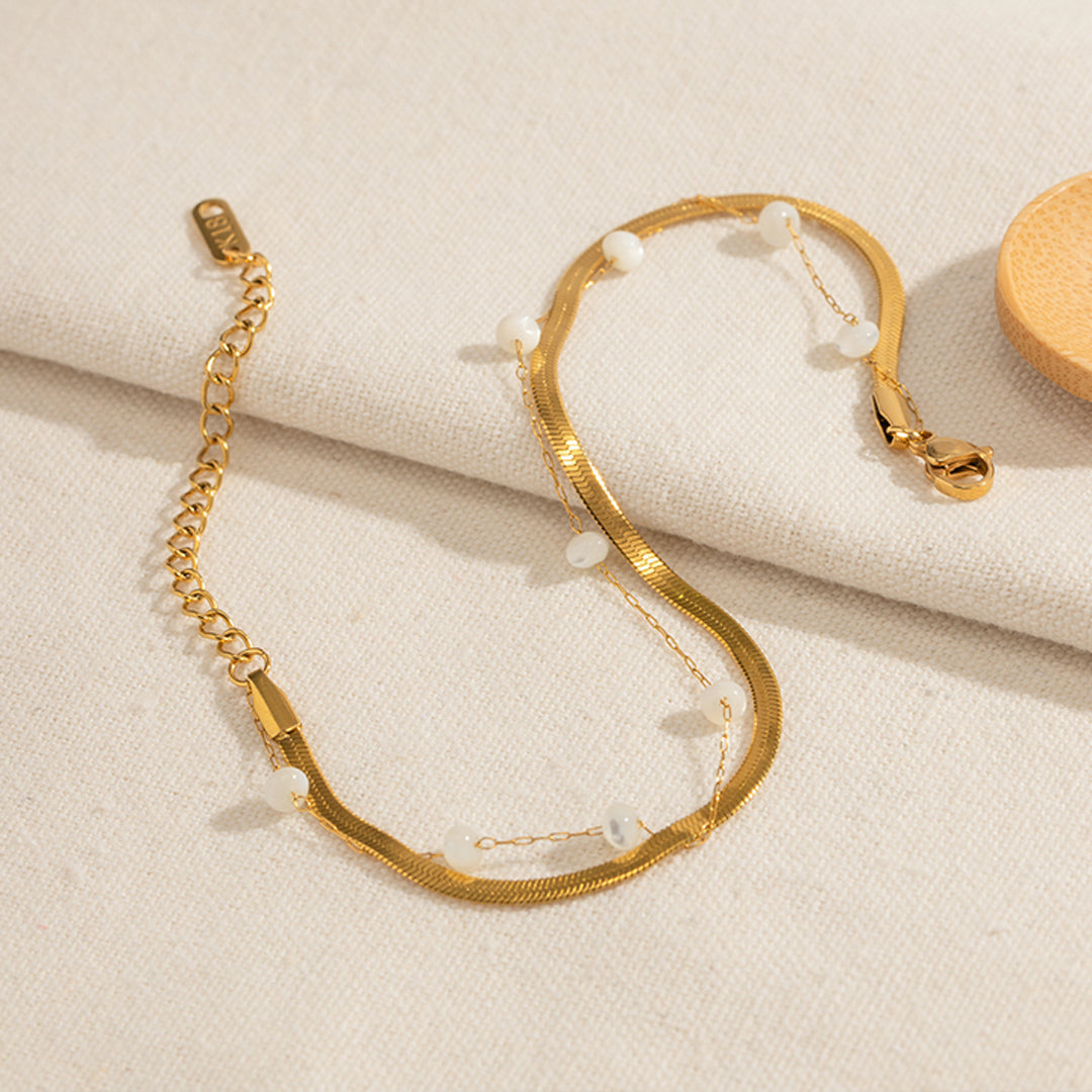Selene Anklet featuring a layered 18K PVD gold plated snake chain with delicate pearl accents.