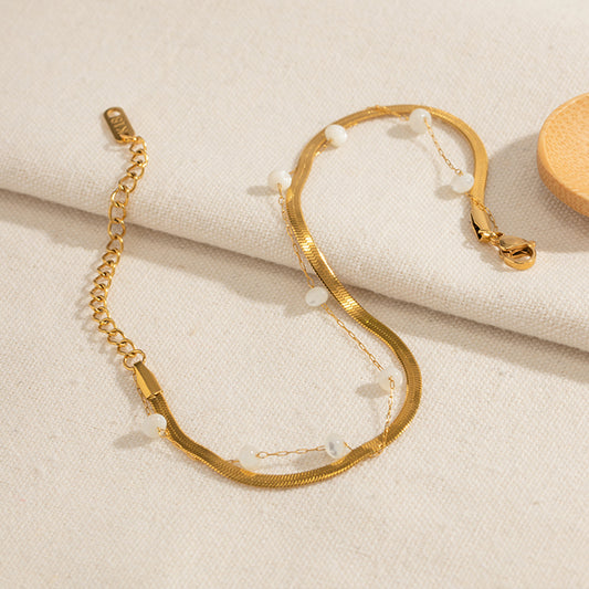 Selene Anklet featuring a layered 18K PVD gold plated snake chain with delicate pearl accents.