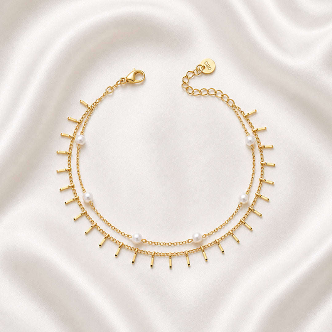 Liora Anklet featuring a layered 18K PVD gold plated chain with pearl accents and delicate fringe charms.