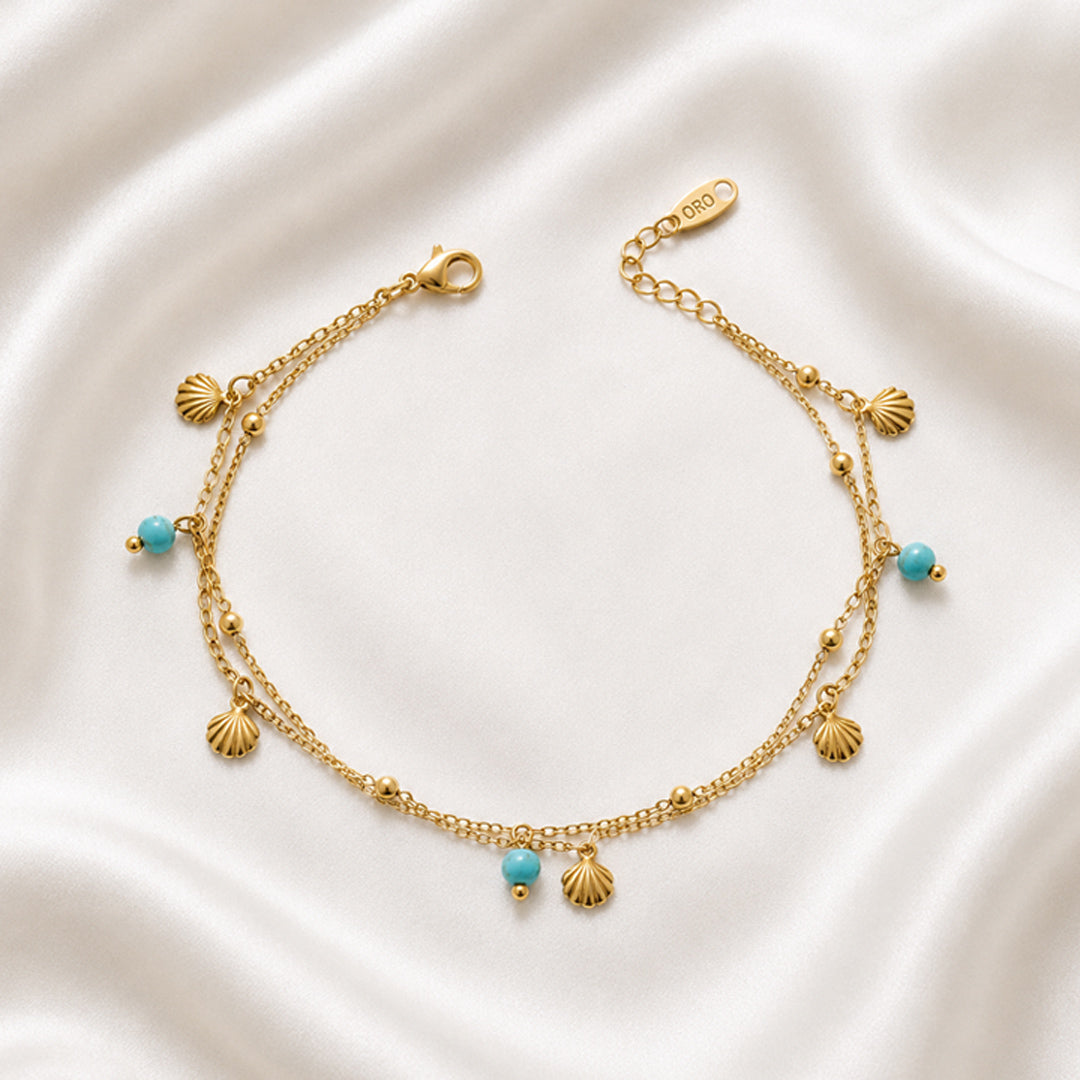 Maris Anklet featuring layered 18K PVD gold plated chains with turquoise-inspired beads and shell charms.