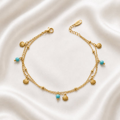 Maris Anklet featuring layered 18K PVD gold plated chains with turquoise-inspired beads and shell charms.