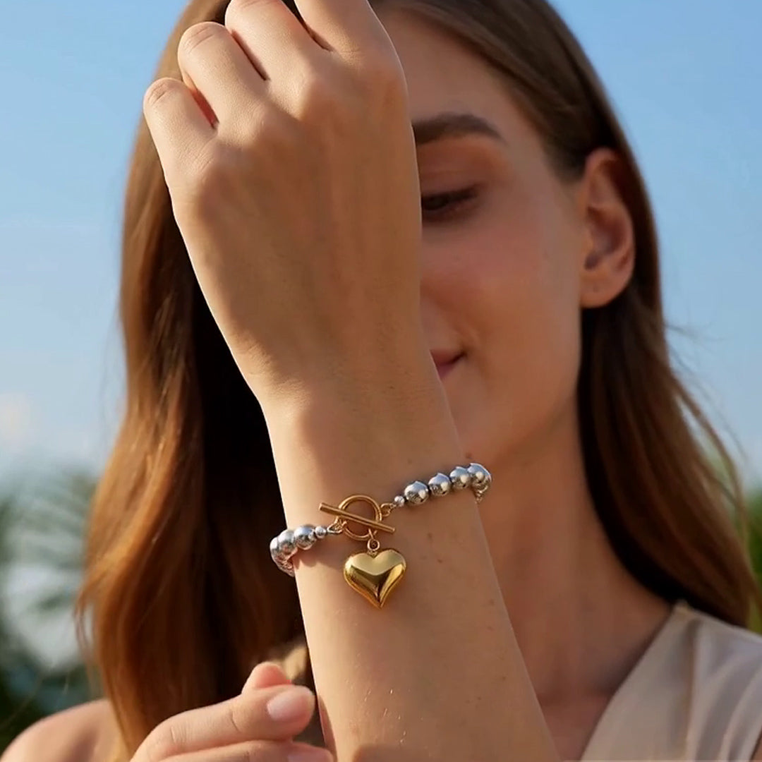 Silver beaded bracelet with polished gold heart charm and toggle clasp by OROR Parure