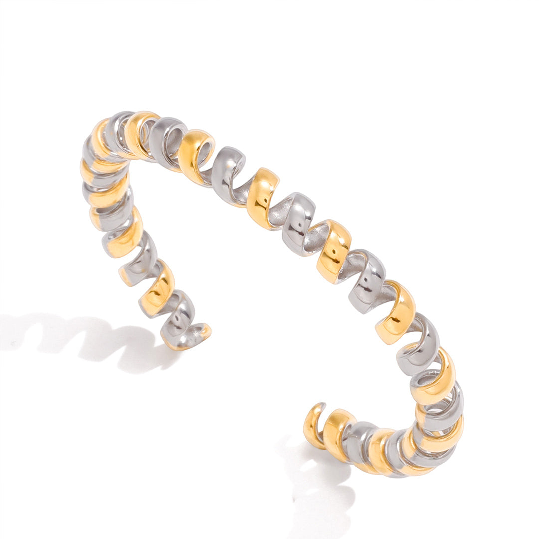 Dual tone spiral cuff bracelet with sculptural gold and silver wrapped open cuff design