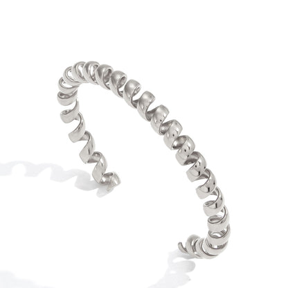 Silver spiral cuff bracelet with sculptural open wrapped design in polished stainless steel