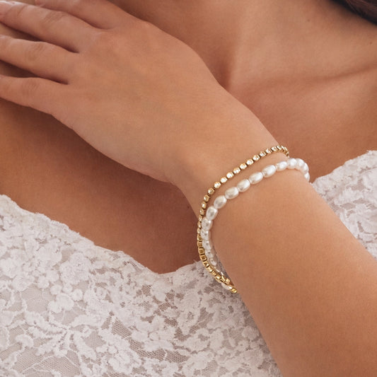 Pearl and crystal double-strand gold toggle bracelet on wrist, freshwater pearls and round crystals