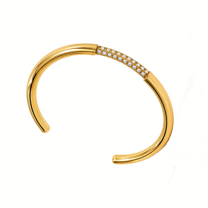 Gold bracelet with small diamonds on a white background