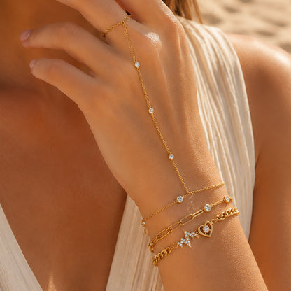 Woman wearing the Celestial Pulse Trio featuring the Étoile Handchain, Aurora Bracelet, and Amour Pulse Bracelet in OROR luxury styling.