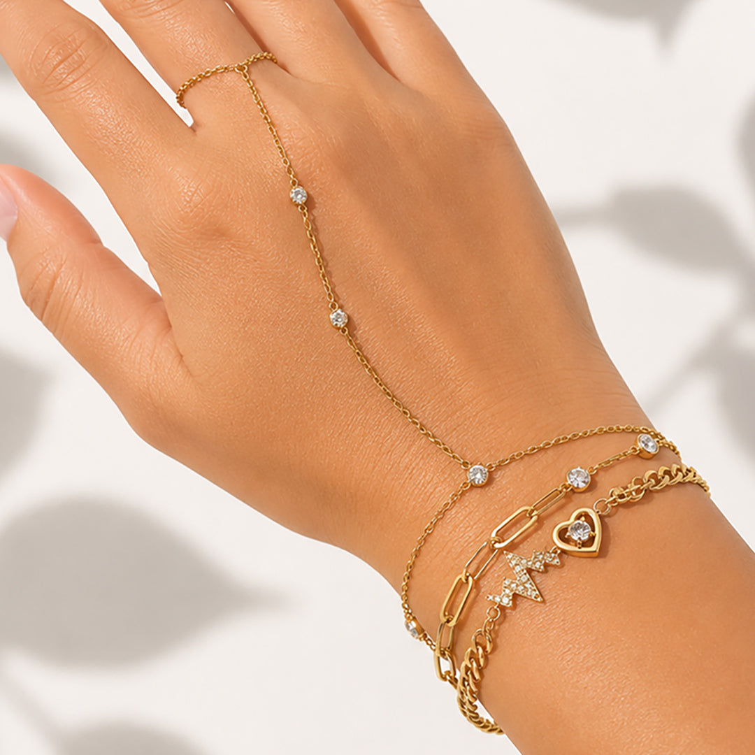 Woman wearing the Celestial Pulse Trio featuring the Étoile Handchain, Aurora Bracelet, and Amour Pulse Bracelet in OROR luxury styling.