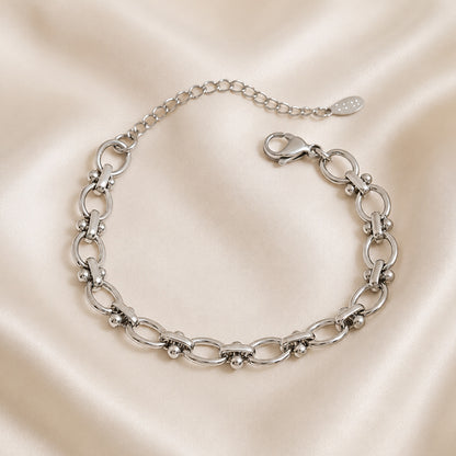 Celestia Link Stainless Steel Bracelet featuring sculptural oval links and polished sphere accents displayed on ivory satin.