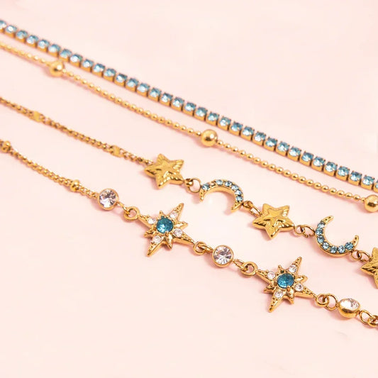 Close-up of star and crescent motif chain bracelets with turquoise zircon accents, gold-plated set