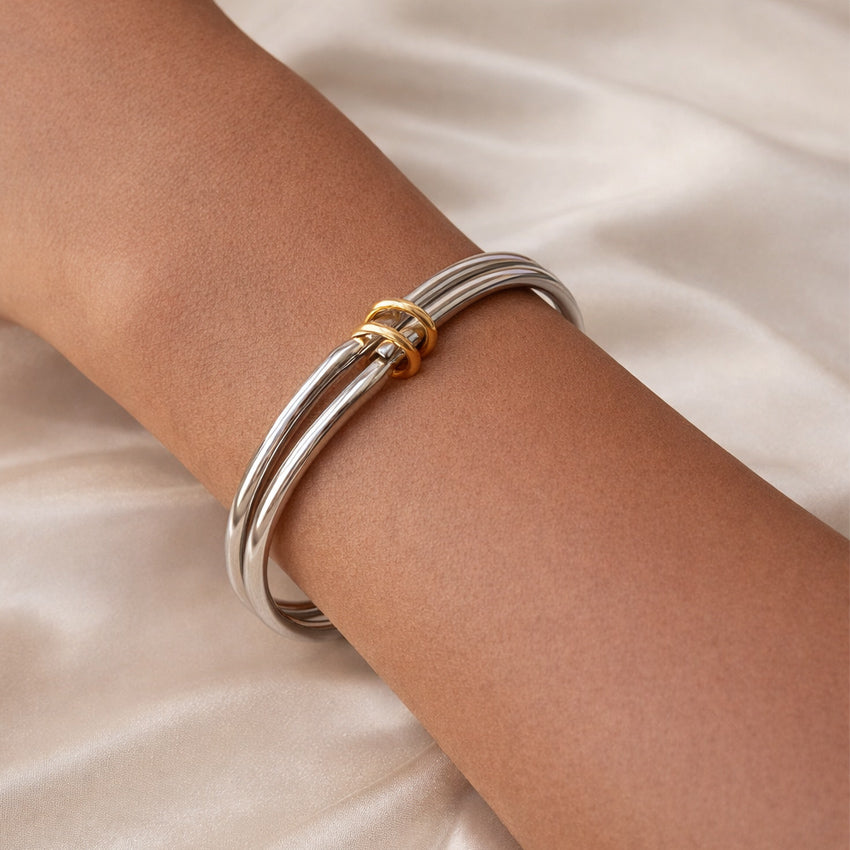 Trinity Double Tone bangle on wrist, silver tone with gold-tone rings
