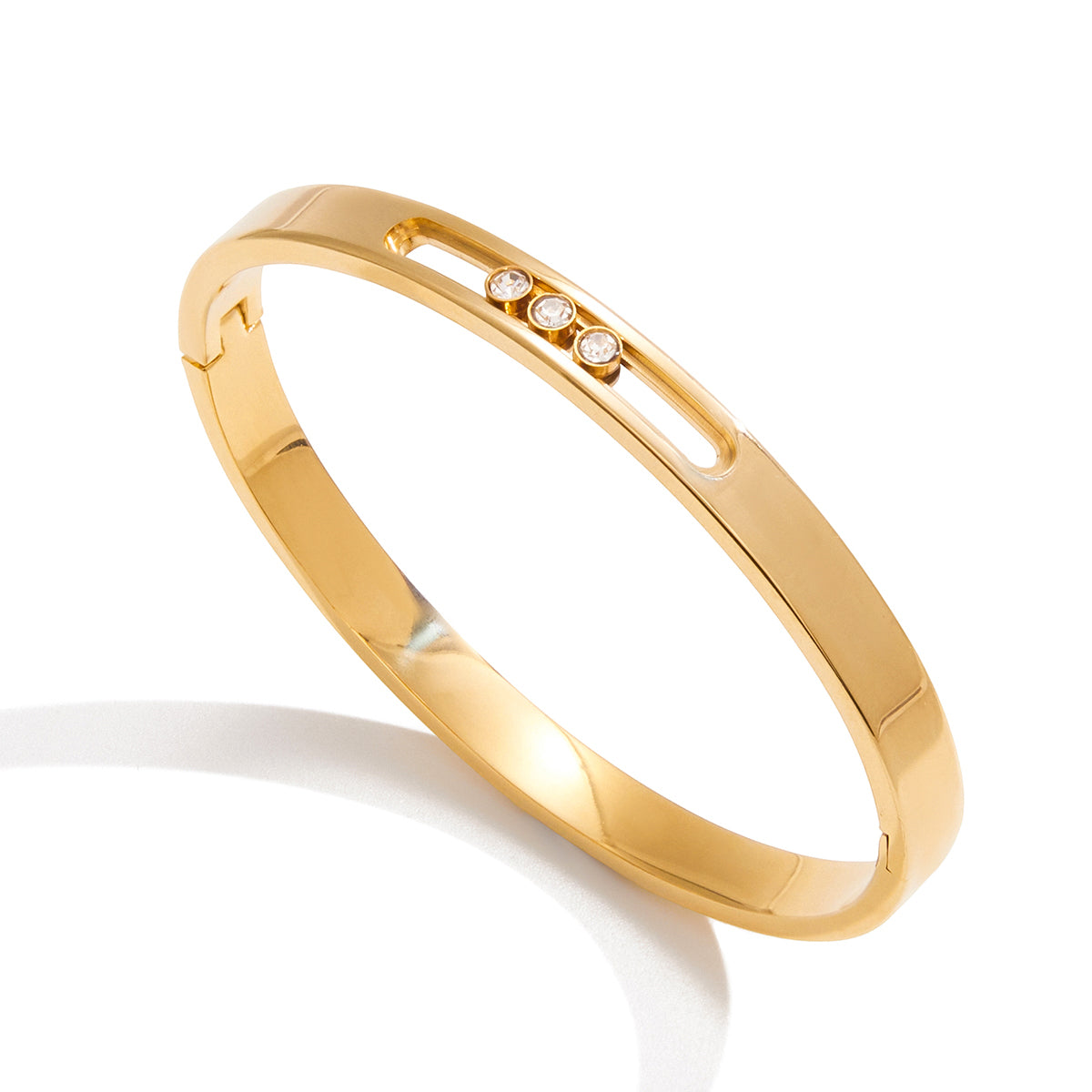 Gold-plated Trio Motion zircon bangle product view with slim track detail and three movable stones