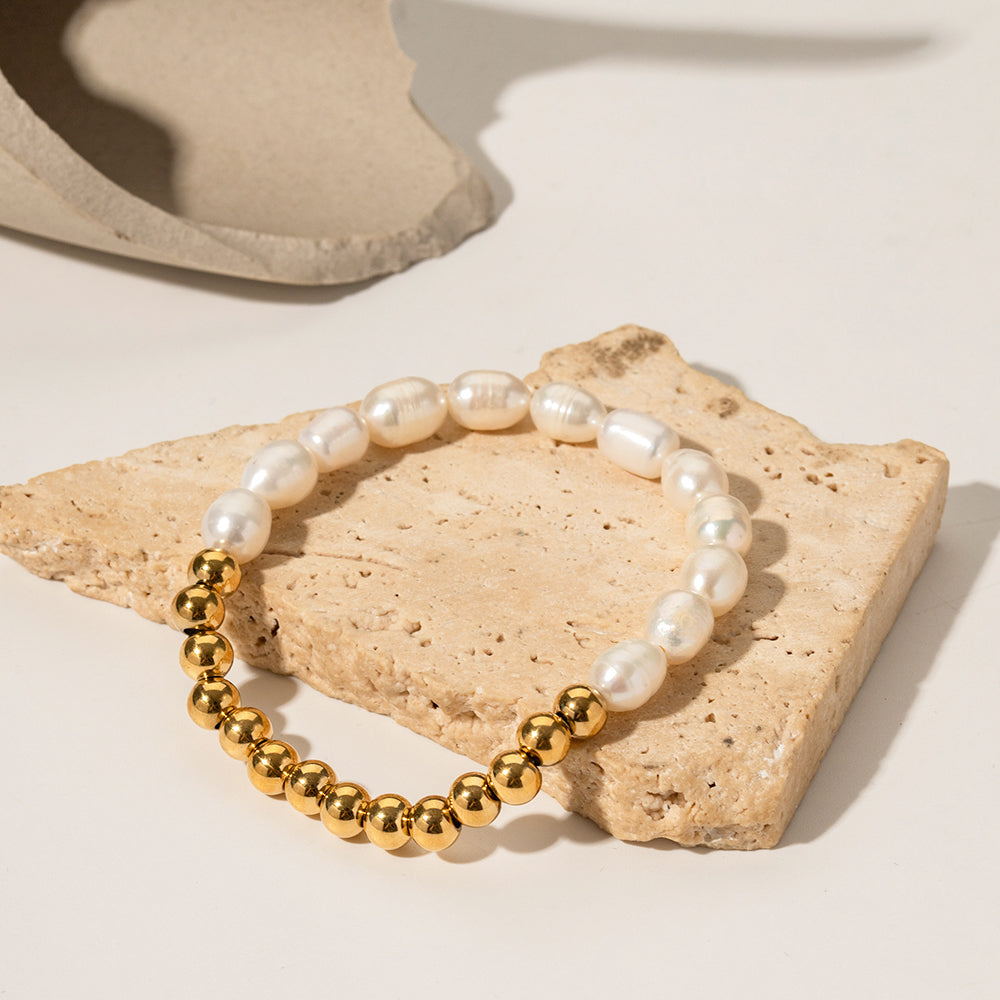Pearl and gold sphere bracelet styled in a stack, freshwater pearls and polished gold beads