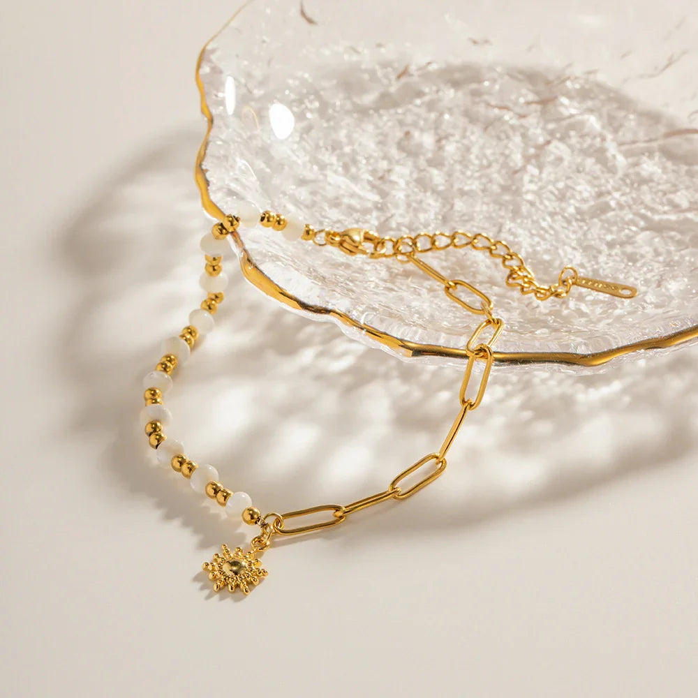 Pearl-effect bead and gold chain bracelet with sun charm, product view with adjustable chain