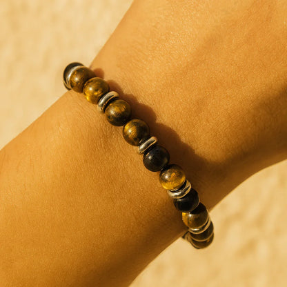 Men’s tiger eye–tone bead bracelet on wrist with polished metallic spacers