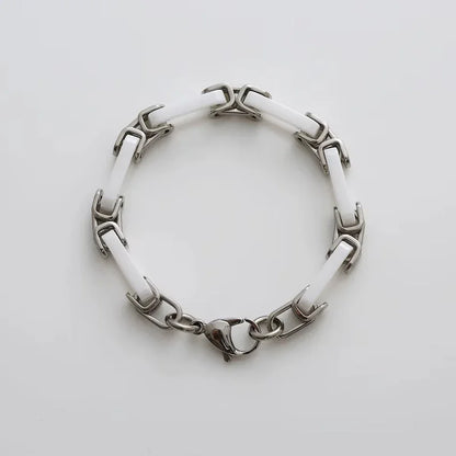 White ceramic chain bracelet top view showing ceramic links and steel connectors
