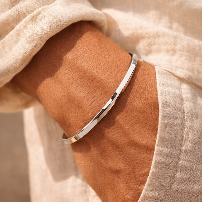 Men’s polished stainless steel open cuff bracelet on wrist