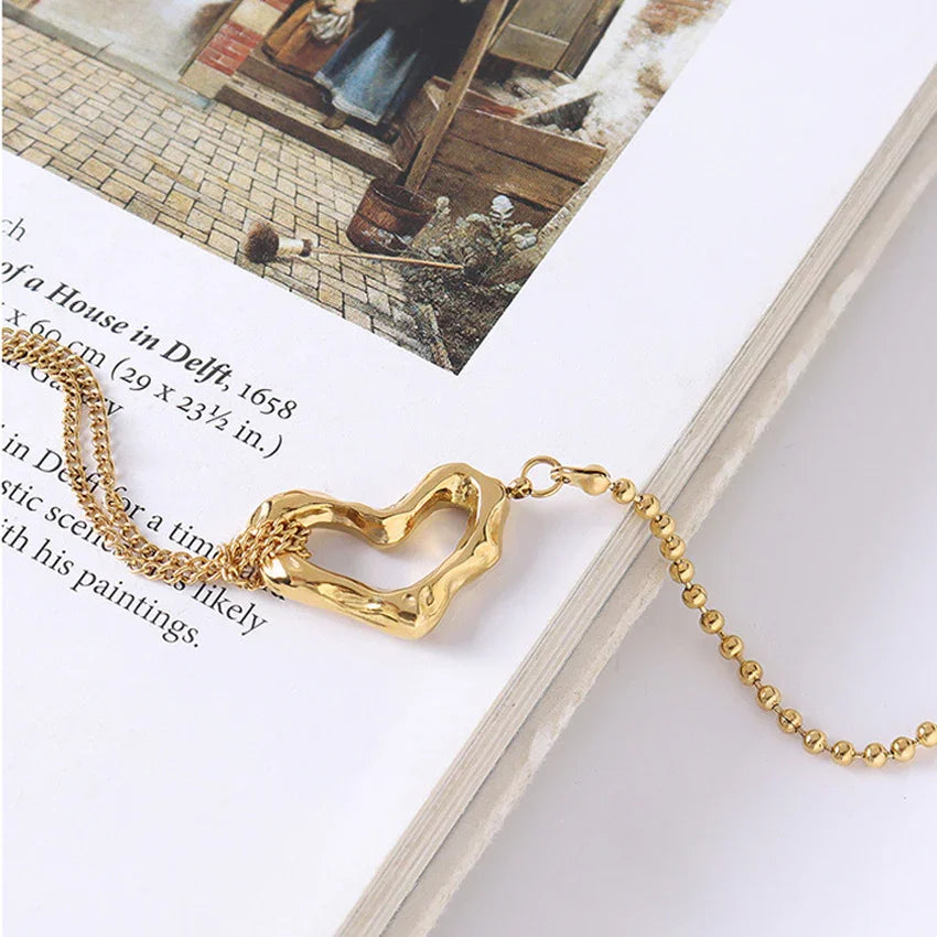 OROR heart chain bracelet styled flat lay, stainless steel with PVD gold finish