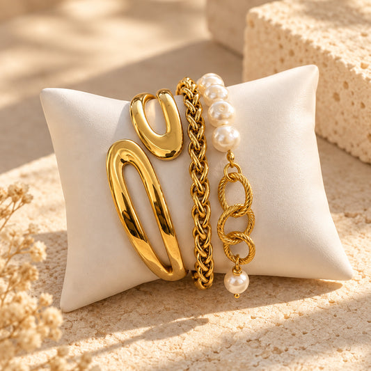 Audacia gold bracelet stack with sculptural cuff, chain and pearl-like accents – OROR Parure