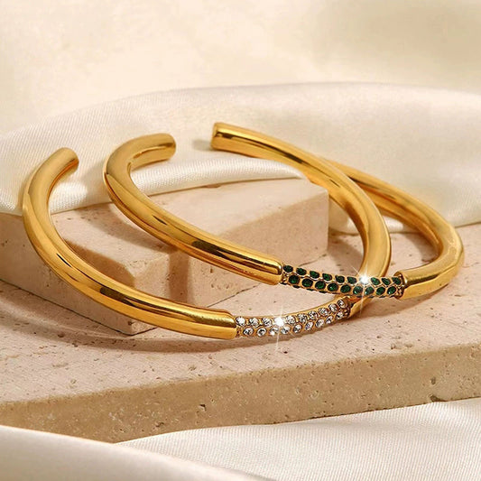 Gold cuff bracelet set with pavé and dark contrast detailing on a woman's wrist, minimal luxury jewelry style