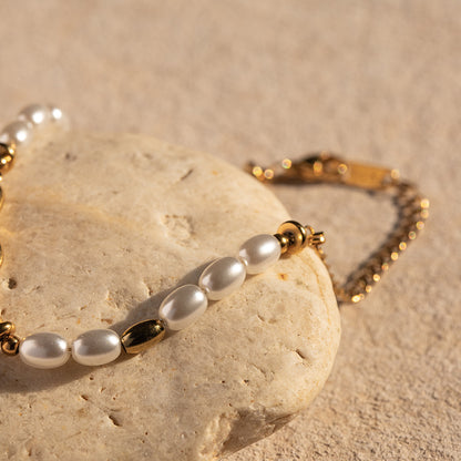 Gold bracelet with lapis blue accents, product view on stone surface