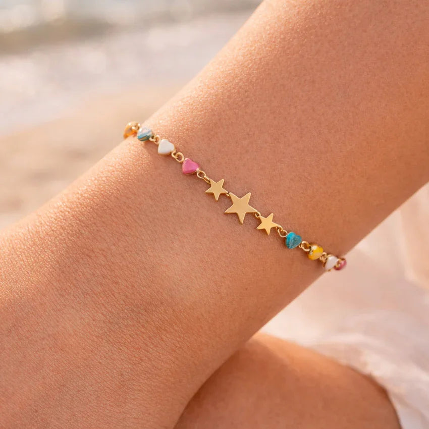 Stella multicolor star bracelet on wrist, gold-plated star motifs with enamel accents
